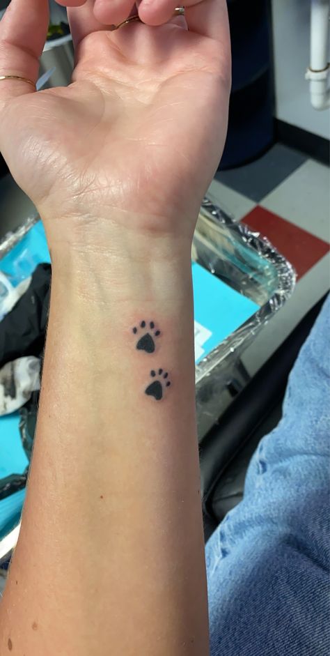 paw prints wrist tattoo Pawprint Tattoo Wrist, Paw Print Tattoo On Wrist, Puppy Paws Tattoo, Paw Print Tattoo Wrist, Paw Prints Tatoos, Dog Paw Tattoos For Women, Paw Print Tattoos, Angle Tattoo, Underarm Tattoo