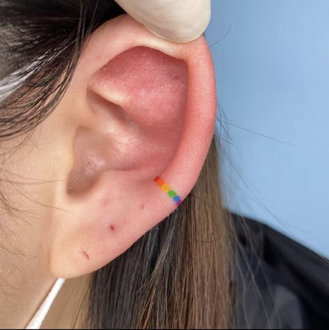 Ear Tattoo Color, Rainbow Tattoo Ear Cuff, Rainbow Ear Tattoo, Minimalist Tattoo Rainbow, Small Tattoos Rainbow, Ear Rainbow Tattoo, Pride Ear Tattoo, Bisexual Tattoo, Harmony Tattoo