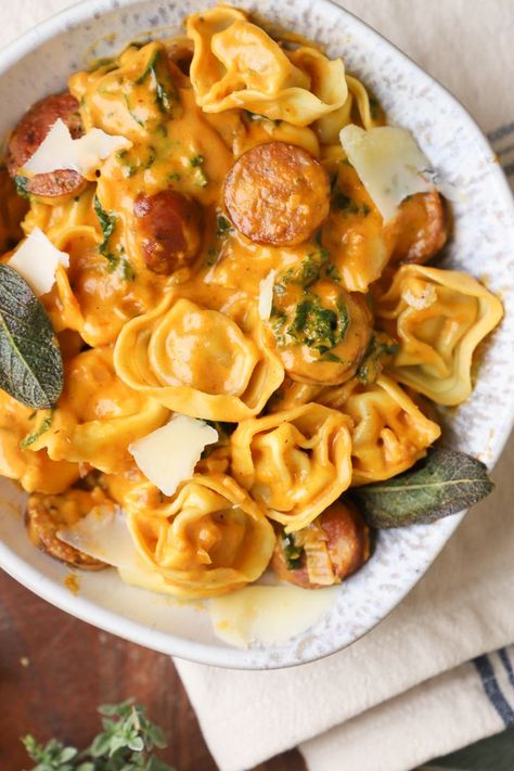 Silky smooth Pumpkin Kale Tortellini alla Vodka Pasta- made with a luscious creamy pumpkin sauce, savory Italian sausage, fresh kale and lots of parmesan cheese. This creamy pumpkin tortellini is the perfect cozy comfort dish on a crisp autumn evening. #pasta #pumpkin #pumpkinpasta #italian #tortellini #fall #fallrecipes #easydinners Kale Tortellini, Pumpkin Tortellini, Alla Vodka Pasta, Pasta Pumpkin, Pumpkin Pasta Sauce, Sage Recipes, Pumpkin Mac And Cheese, Veggie Sausage, Sausage Tortellini