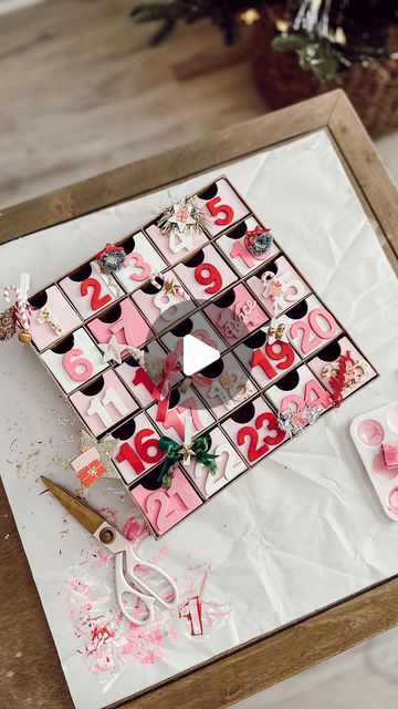 JAMIE THORPE | HOME DECOR | COASTAL LIVING | SHOPPING FINDS on Instagram: "DIY ADVENT CALENDAR 🎅🏽🎄🎁✨ SAVE AND SHARE THIS POST TO MAKE YOUR OWN.   WHAT YOU NEED I grabbed this cardboard advent calendar, and 5 packs of wooden numbers from Hobby Lobby plus acrylic paint (colors listed below)   ACRYLIC PAINT COLORS Here are the exact colors I used: (From Hobby Lobby) Folk Art “Ivory white” Folk Art “Baby Pink” Crafter Collection “Princess pink” Crafter Collection “Pink” Crafter Collection “Christmas Red” *Don’t forget the paint brushes.  WHAT I PUT INSIDE I added little hand written notes in the boxes. Each day with clues on them telling where to go find a fun Christmas themed surprise and a bible verse. Every other day I put a small piece of candy  DECORATE IT To decorate it, I only bough Diy Candy Advent Calendar, Paint Your Own Advent Calendar, Cardboard Advent Calendar Diy, Diy Wooden Advent Calendar, Acrylic Paint Colors, Hand Written Notes, Advent Box, Home Decor Coastal, A Bible Verse