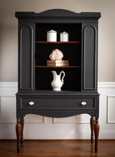 "I just love how this vintage china hutch turned out. Painted in a custom mix of General Finishes Lamp Black and Queenstown Gray, a gorgeous color was made. I’ll call it Graphite Gray! The legs and shelves were stripped to bare wood and stained in walnut gel stain. New hardware complete the look. I just love her new makeover. Definitely a one of a kind piece" - Vintage Actually Decor Painted Dresser Makeover, Armoire Makeover Black, Moody Furniture Makeover, Painted Grey Furniture, Small Hutch Makeover, Modern Hutch Makeover, Black Hutch Makeover, Refurbished Hutch Ideas, Black Antique Furniture