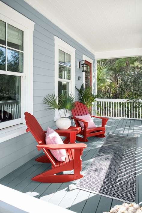 A comfortable coastal porch featuring Benjamin Moore Nimbus Gray 2131-50 and Caliente AF-290, the perfect paint colors for a look that is fun, but still traditional for the exterior of your home. Deck Paint Colors, Nimbus Gray, Renovation Exterior, Red Chairs, Porch Paint, Deck Colors, Deck Paint, Painted Patio, Pintura Exterior