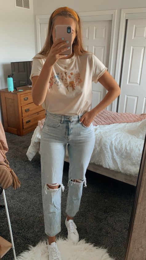 Light wash jeans, white sneakers, and a floral graphic tee Graphic Tee Outfit Jeans, Tee Shirt And Jeans Outfit Casual, Ae Mom Jeans Outfit, Jeans And Graphic T Shirt Outfit, Graphic Tee And Jeans Outfit, Rip Jeans Outfit, Casual Spring Outfits Jeans, Ripped Jeans Outfit Spring, Ripped Boyfriend Jeans Outfit