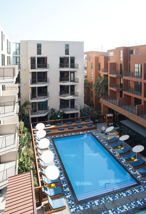 A view of the complex's pool which sits in the center of the shared central space. Rectangle Swimming Pools, Hollywood Apartment, Rectangular Swimming Pools, Apartment Pool, Rectangle Pool, Apartment Buildings, Rectangular Pool, Natural Swimming Pools, Hotel Pool