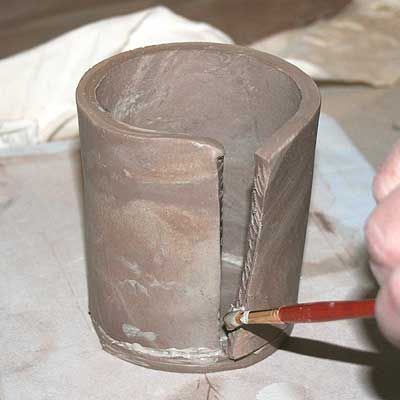 Create and attach the wall for the pottery mug, making sure to slip and score all joints. - Photo © 2009 Beth E Peterson Slab Pottery Templates, Pottery Templates, Handbuilt Pottery, Slab Ceramics, Pottery Lessons, Beginner Pottery, Pottery Videos, Pottery Handbuilding, Hand Building