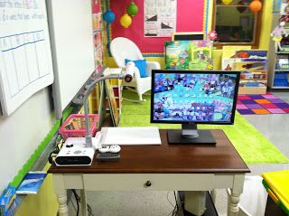 Keeping your supplies next to your Smartboard can be a CHALLENGE. Check out how this teacher has set up a permanent station for her document camera and projector remotes. The little drawer is great for whiteboard markers and other supplies you need within reach. Modern Teacher, Teaching Organization, Classroom Layout, Class Organization, Organization And Management, Classroom Organisation, Teacher Desk, First Grade Classroom, Teacher Organization