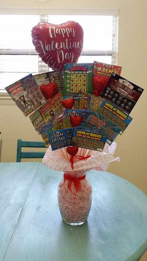 Made this lottery ticket bouquet for my husband for Valentine's Day this year! Works great for any occassion!  Supplies -Lottery tickets -Skewer sticks (walmart) -green foam (Dollar Tree) -vase (Dollar tree) -glitter hearts (walmart) -tissue paper -misc decor pieces  Pretty self explanatory, just wanted to share what I used and where I found them. Have fun making it for your special ocassion! 😀 Lottery Ticket Bouquet, Decoration Ideas For Valentines Day, Saint Valentin Diy, Valentines Bricolage, Tree Decoration Ideas, Valentine Gift Baskets, Valentine's Day Gift Baskets, Valentines Gift Bags, Valentines Day Pictures