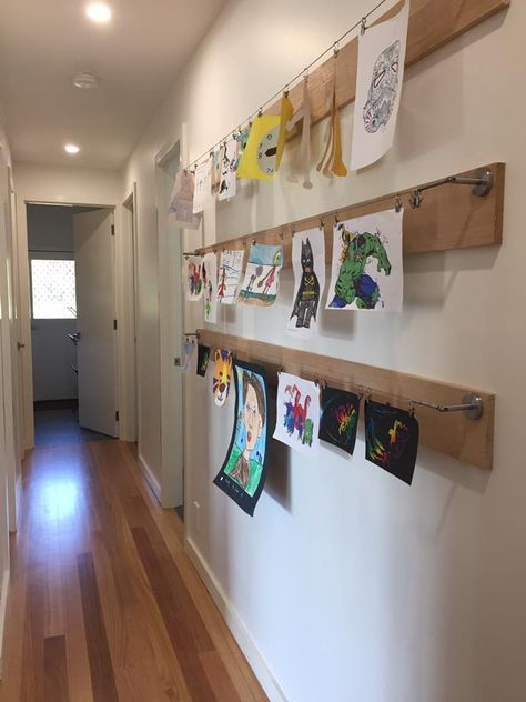 Weekend project! (seen on google images originally). An art wall in the children's hallway. We used some left over Tassie oak pieces which we sanded. Then we attached the IKEA Dignitet Curtain Wires ($12.99 a set) plus some IKEA Riktig curtain hooks ($4 pack). Ikea Dignitet, Curtain Wire, Displaying Kids Artwork, Basement Playroom, Kids Artwork, Weekend Projects, Artwork Display, Display Storage, Play Room