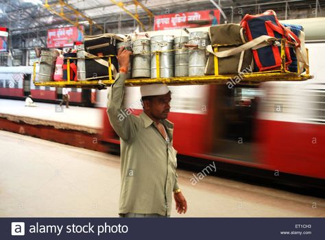 Download this stock image: Dabbawala carrying lunchboxes on head Churchgate Station Bombay Mumbai Maharshtra India - ET1CH3 from Alamy's library of millions of high resolution stock photos, illustrations and vectors. Solar Punk, India Images, India Asia, Mumbai Maharashtra, Reference Photos, Fencing, Mumbai, Carry On, Art Reference