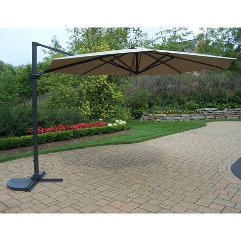 The ultimate in shade, quality and ease of operation! The Santorini II cantilever umbrella brings elegant shade to your patio as well as effortless operation. The giant square canopy provides 100 sq ft of shade. A single wind vent at the top of the canopy facilitates airflow, allowing air to escape freely and preventing the umbrella from inverting during windy days. The clean, modern styling of the canopy makes it an attractive addition to any backyard. A rugged anodized aluminum pole with ma... Pagoda Umbrella, Deck Umbrella, Laying Decking, Beachfront House, Patio Umbrella Stand, Deck Construction, Offset Umbrella, Cantilever Umbrella, Design Toscano