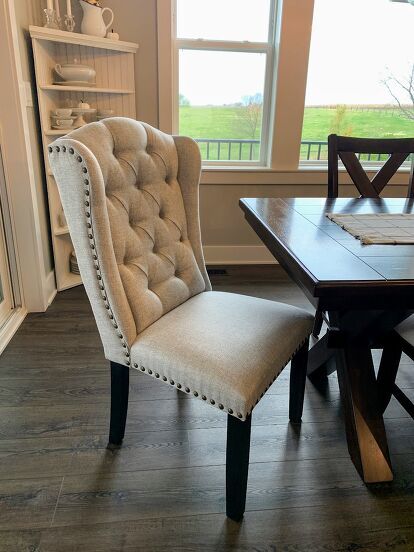 It’s DIY time again, and this time I’m sharing how I gave my dining area an easy and inexpensive makeover with this simple Chair Cover DIY using painter’s drop cloth.And by simple, I mean really simple. Can you operate a staple gun? Then you can completely recover your chairs in an hour or two, depending on how many chairs you have.BEFORE my Chair Cover DIYHere’s my “before” picture… I love our dining table because it’s big and can seat a lot of people. Here it is with 8 chairs, but… Chair Cover Diy, Dining Room Chairs Diy, Recovered Dining Chairs, Amazon Chair, Diy Chair Covers, Queen Anne Chair, Simple Chair, Chairs Diy, Spindle Chair