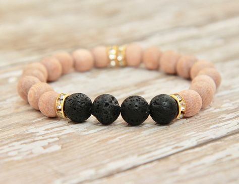 This bracelet is handmade out of Rosewood beads (unwaxed, 8mm), 4 black lava rock beads (8mm), and gold rhinestone spacers. Each beautiful bead combination is made on a strong, stretchy, elastic cord. This earthy, trendy, and comfortable bracelet is great for everyday wear! Natural lava rocks are very porous and absorb essential oils well. Directly apply 1-2 drops of your favorite essential oil to the lava rock beads. Due to the absorbent nature of the materials, you will be able to enjoy the be Essential Oil Accessories, Lava Rock Bracelet, Essential Oil Bracelet, Aromatherapy Bracelet, Oil Diffuser Bracelet, Aromatherapy Jewelry, Diffuser Jewelry, Hematite Bracelet, Diffuser Necklace