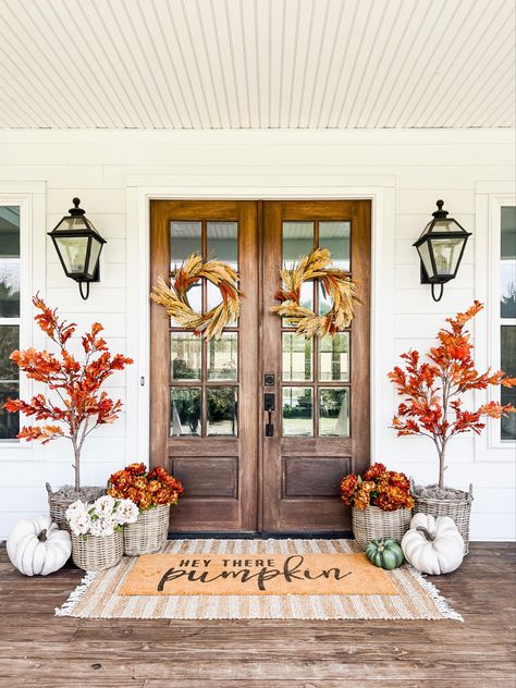 Front porch and door decor fall autumn harvest seasonal entry French double doors oversized layered scatter rug and doormat pumpkin magnolia trees faux artificial silk florals mums baskets wreaths outdoor lanterns wall sconces rocking chairs light fixtures southern modern farmhouse style home decor nearly natural amazon finds Etsy wayfair marshalls TJ Maxx home goods Walmart autumn oak trees Follow my shop @brunoandlibby on the @shop.LTK app to shop this post and get my exclusive app-only cont Southern Fall Porch Decor, Mums Porch, Front Porch Flower Pots, Porch Fall Decor, Front Porch Flowers, Porch Flowers, Silk Florals, Fall Tree, Fall Front Porch Decor