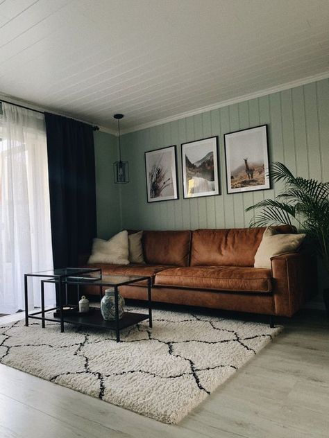 Picture Of a modern living room with sage green slatted walls, a brown leather sofa, black metal and glass tables and a gallery wall Sage Living Room, Green Walls Living Room, Sage Green Living Room, Green Living Room Decor, Sage Green Bedroom, Living Room Color Schemes, Green Home Decor, Living Room Green, Green Rooms