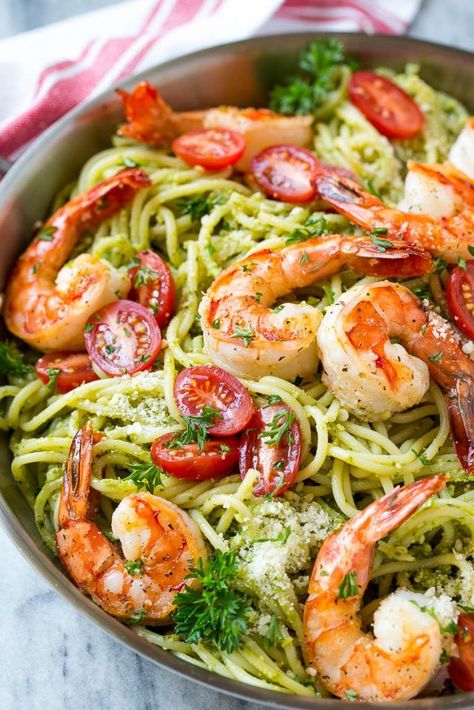 This recipe for shrimp pesto pasta is spaghetti tossed in a flavorful pesto sauce, then topped with sauteed shrimp and tomatoes. A fresh and easy dinner that's quick to make and packed with flavor! Shrimp And Pesto, Shrimp Pasta Recipes Healthy, Shrimp Pasta Healthy, Shrimp Pesto Pasta, Pasta With Shrimp, Pesto Pasta Recipe, Red Sauce Recipe, Pesto Shrimp, Sauce Pesto