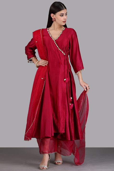 Featuring a maroon angrakha kurta in chanderi silk base. It is paired with matching silk pants and an organza zari scalloped dupatta.  FIT: Fitted at bust and waist. COMPOSITION: Chanderi silk, Silk, Organza. CARE: Dry clean only. Plan Silk Kurti Designs Latest, Brocade Kurta Designs Women, Pure Silk Suit Designs Indian, Kurta Sets For Women Party Wear, Traditional Silk Kurta With Dupatta, Chanderi Silk Suit Designs Indian, Raw Silk Kurta Designs Women, Ethnic Suits For Women, Plain Suit Designs Indian