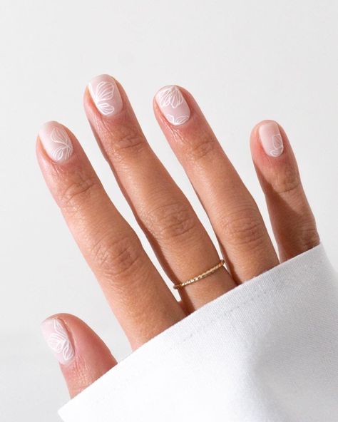 A hand with short milky white nails with white floral outlines #womensfashion #naildesign #springnails #nails #naildesigntrends Uñas Color Coral, Ladybug Nails, White Chrome Nails, Milky Nails, Nude Nail Designs, Floral Nail Designs, Cute Spring Nails, Wedding Nails Design, White Nail