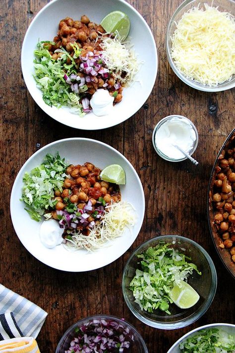 I’ve long wondered if chickpeas could stand in for ground meat in my favorite taco recipe. This month’s Food and Wine, which featured a recipe with a chickpea-for-pasta swap encouraged me to finally give it a try. It worked beautifully, the method needing only a slight adjustment—double the amount of crushed tomatoes and water—because chickpeas soak up... Chickpea Taco, Tacos Vegetarian, Chickpea Tacos, Veggie Bowls, Chickpea Chili, Quick Pickled Onions, Taco Bowl, Dry Chickpeas, Taco Recipe