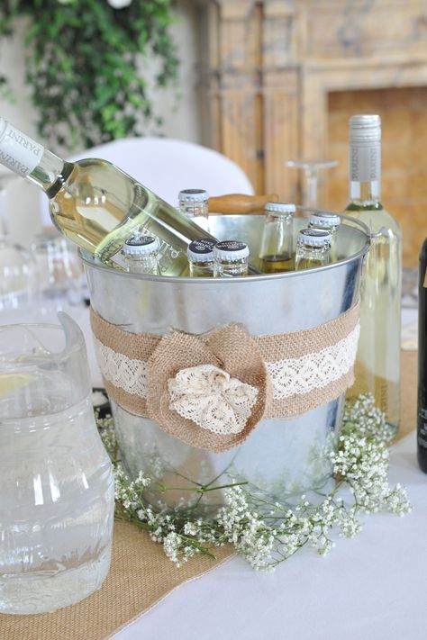 Ice buckets as table centrepieces, burlap/hessian and lace added. Gypsophila added around the base to finish! Wine Bucket Centerpiece, Wedding Ice Bucket, Bucket Wedding, Bucket Centerpiece, Rooftop Wedding Venue, Hanging Centerpiece, Mini Wedding Cakes, Beer Bucket, Champagne Bucket