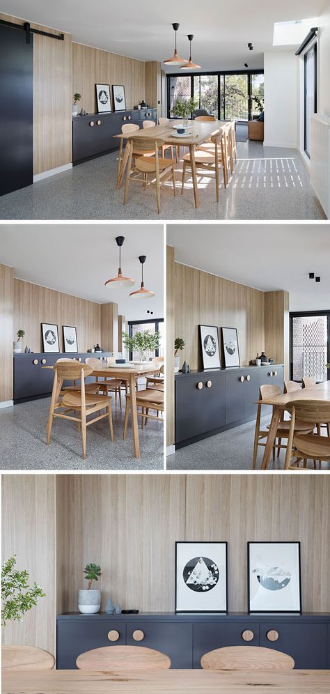 In this modern dining room, light wood dining table and chairs play off the light wood walls, and a matte black built-in sideboard with wood handles provides ample storage and a place to display decorative items. 1970s Colonial, Wood Table Chairs, Built In Sideboard, Brown Brick Houses, Light Wood Dining Table, Gray And White Bathroom, Hall Ideas, Light Wood Cabinets, Dining Wall