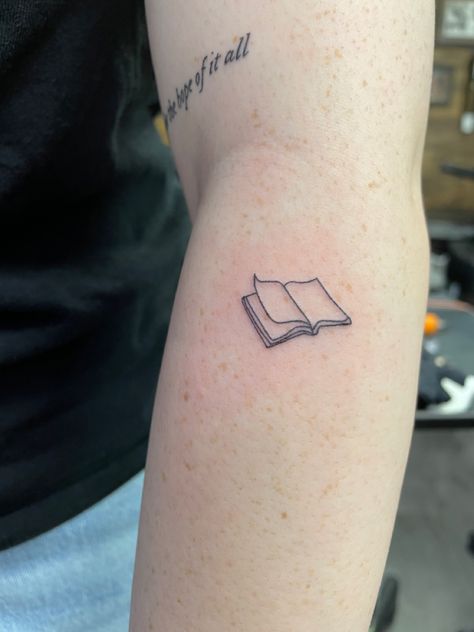 Book Tattoo Minimal, Fine Line Typewriter Tattoo, Simple Tattoos For Book Lovers, Book Tiny Tattoo, Pride And Prejudice Tattoo Small, Literature Tattoo Ideas, Literature Tattoos Minimalist, Book Tattoo Simple, Book Outline Tattoo