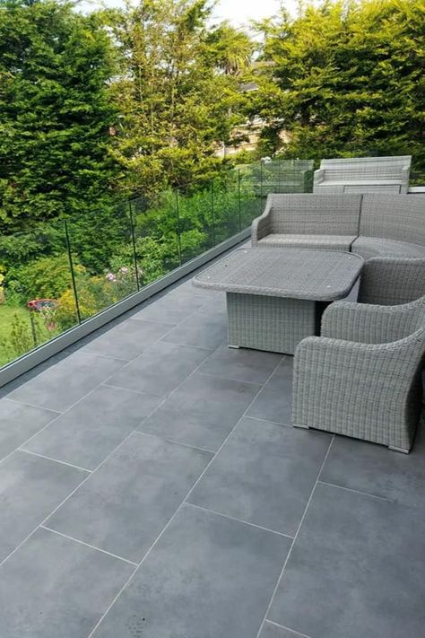 A light shade of grey porcelain paving, Grey Dusk is ideal for creating modern outdoor living spaces. Offering a smooth and polished finish, it fives the appearance of concrete for a contemporary feel. Dark Grey Porcelain Patio, Grey Porcelain Paving, Grey Patio Paving, Outdoor Paving Ideas, Porch Tiles, Modern Outdoor Living Space, Contemporary Outdoor Living, Patio Paving, Grey Paving