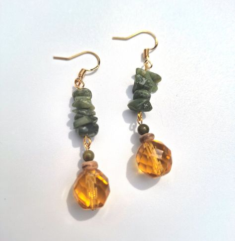 Earthy bohemian style gemstone gold dangle earrings; crafted with green serpentine stone chips, 4 mm polished unakite stone, natural coconut shell heishi beading, and a beautiful amber colored Czech glass beading.  Click on the link below if you would like to see more artisan jewelry and unique artwork! https://www.etsy.com/shop/CailinCreatesCo Cottagecore Earrings, Earthy Bohemian, Serpentine Stone, Earthy Jewelry, Nature Earrings, Stone Chips, Gold Dangle Earrings, Witchy Jewelry, Rustic Jewelry