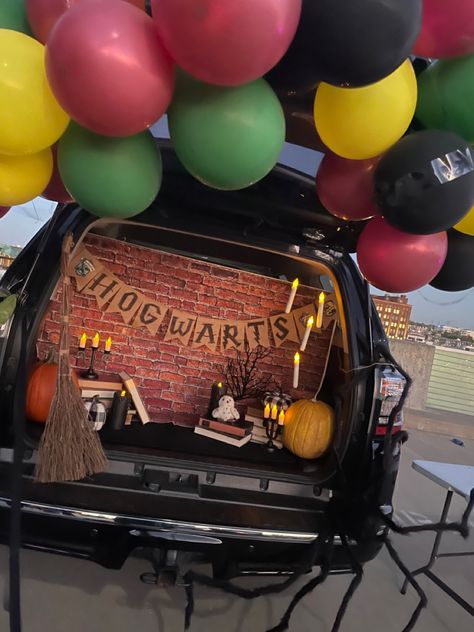 Harry Potter trunk with a balloon arch, Hedwig, a broom, books, floating candles, and a spider Harry Potter Quidditch Trunk Or Treat, Trunk Or Treat Ideas For Cars Teacher, Adult Trunk Or Treat Ideas, Harry Potter Truck Or Treat, Trunk Or Treat Ideas For Cars Harry Potter, Harry Potter Themed Trunk Or Treat, Trunk Or Treat Ideas Harry Potter, Jeep Wrangler Trunk Or Treat Ideas, Kid Friendly Trunk Or Treat Ideas