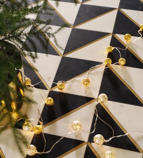 A Classic Combination: They say don't mess with the classics. But what if you can make them better? Gold is a natural fit if you want to introduce a little glam to the traditional black and white tile. Plus, some holiday lights and pine trees never hurt anyone! Check out more silver and gold inspired tile looks just in time for the holidays. Entryway Tile, Black Backsplash, Black Floor Tiles, Gold Tile, Gold Mosaic, Glass Extension, White Tile Floor, Mosaic Floor Tile, Shore House