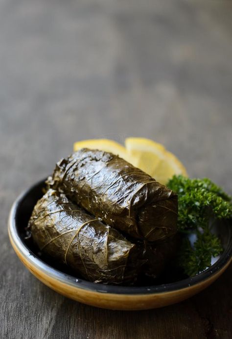 Dolmades recipe. These mouth watering dolmades are filled with rice and herbs, and served with a little squeeze of lemon. Superb as entree. #dolmade #fingerfood #entree Dolmades Recipe, Grape Leaves Recipe, Stuffed Vine Leaves, Fish Recipes Baked, Roast Fish, Stuffed Grape Leaves, Grain Foods, Baked Fish, Turkish Recipes