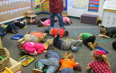 Whooo's Having an Owl-Fall Lot of Fun at Preschool??? at For the Children. Science, craft, exploration, and gross motor combine in this comprehensive lesson on owls that any age child would love. The picture illustrates kids playing opossum [i.e. playing dead] when a predator owl is near. Opossum Preschool Activities, Nocturnal Animal Gross Motor, Owl Science Activities For Preschool, Owl Gross Motor Activities, Nocturnal Animals Gross Motor Activities, Nocturnal Animal Activities Preschool, Forest Animal Theme Preschool, Owl Activities For Preschool, Owls Preschool