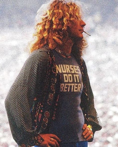 @rocknrroll’s Instagram profile post: “Robert Plant wearing his 'Nurses Do It Better' T-shirt (to honor his then wife, Maurine Wilson, a certified nurse!), Oakland • 1977” Robert Plant Young, 70s Bands, Nurses Do It Better, Oakland Coliseum, Robert Plant Led Zeppelin, John Paul Jones, John Bonham, Led Zep, Do It Better