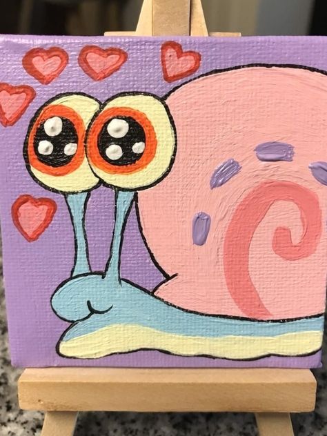 Gary the snail, in love. From Spongebob Squarepants. Great for any fan! Hand drawn and painted on 2.5x2.5 mini canvas. You can get purple or turquoise backgrounds! Mini easel included with painting. Each painting is made to order and may vary slightly. Sprayed with a protective sealant. If unsatisfied in any way when your painting arrives to you or it’s damaged from shipping, please let me know right away. Costumer satisfaction is top priority in my shop. #painting Snail Spongebob, Spongebob Aesthetic, Gary The Snail, Mini Tela, Shop Painting, Canvas Art Painting Acrylic, Spongebob Painting, Fan Hand, Mini Easel