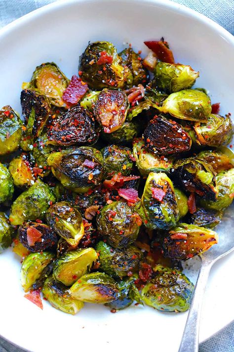 These roasted Brussels sprouts are tossed with maple syrup and bacon grease, cooked to crispy perfection, then topped with the crumbled cooked bacon. The bacon crisps up in the oven on the baking sheet while the oven preheats, saving time and dishes! You'll love this sweet, salty, smoky way to cook Brussels sprouts. Brussels Sprouts And Bacon, Sprouts And Bacon, Bacon Crisps, Eat More Vegetables, Apple Maple, Bacon Brussel Sprouts, Bacon Recipe, Roasted Brussels Sprouts, Sprouts With Bacon