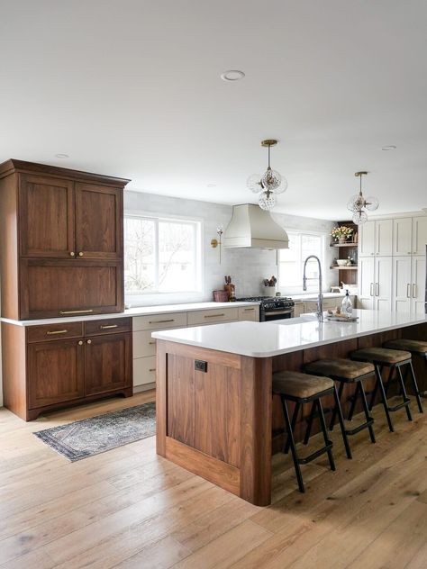 Walnut kitchen cabinets are trending. But should they be? Learn the pros and cons of walnut kitchen cabinets, plus some current design ideas! #walnutkitchen #walnutcabinetry #walnutkitchendesign #kitchendesign #walnutcabinets #kitchendesignideas #woodkitchencabinets All Wood Island, White Bottom Cabinets Dark Top Cabinets, Wood Stain Cabinets Kitchen, Brown Cabinets White Counter, Walnut Cabinets Kitchen, Dark Wood Island, Wood Top Kitchen Island, Kitchen Remodel Dark Cabinets, Grace In My Space