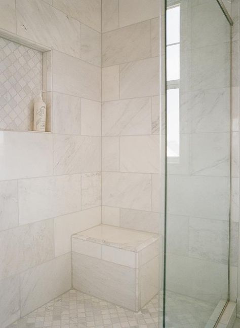 Walk in shower features a built in marble bench with marble quatrefoil floor tiles and a tiled niche. Tile Shower With Niche And Bench, Shower Cubby Accent Tile, Cultured Marble Shower With Tile Accent, 4x4 Shower With Bench, No Grout Shower Walls Marble, Built In Shower Shelves Marble, Tiled Niche, Shower Floor Tiles, Herringbone Wall Tile