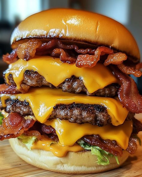 Triple Bacon Cheeseburger 🧀🥓🍔 Ingredients - 2 lbs ground beef (80/20 blend for juicy burgers) - 9 slices cheddar cheese - 9 slices crispy bacon - 3 brioche or sesame seed buns - Salt and pepper to taste - Optional toppings: lettuce, tomato, pickles, onions - Optional condiments: mayonnaise, ketchup, mustard Instructions 1. Preheat your grill or skillet to medium-high heat. 2. Divide the ground beef into 9 equal portions and form into patties. Season with salt and pepper. 3. Cook th... Triple Cheeseburger, Pickles Onions, Eating Burger, Do It For Her, Pineapple On Pizza, Food Combos, Cheese Burgers, Juicy Burgers, Juicy Burger