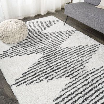 Inspired by Moroccan rugs, our modern striped rug has a soft, low shag pile. The geometric pattern is woven in black on an ivory background; our diamond stripe design has mid-century flair. Add graphic punch to your living room, bedroom, or reading nook with this easy-care rug. Rug Size: Rectangle 3' x 5' | Latitude Run® Collenn Geometric Ivory/Dark Gray Area Rug Polypropylene in White, Size 60.0 H x 36.0 W x 1.37 D in | Wayfair Coastal Area Rugs, Contemporary Cottage, Ivory Background, Natural Fiber Rugs, Dark Gray Area Rug, Gray Area Rug, Shag Area Rug, Baby Boy Nursery, Vintage Moroccan Rugs