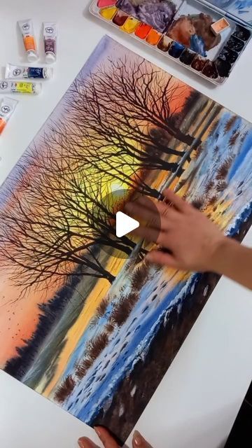 Watercolor Art Gallery on Instagram: "This awesome watercolor painting captures the serene beauty of a winter sunset in stunning detail. The vibrant hues of orange and yellow gracefully melt into cool tones of blue and white, reflecting the warmth of the setting sun against the icy stillness of a snowy landscape. The bare trees, silhouetted against the glowing sky, add a striking sense of depth and tranquility.

The use of the wet-on-wet watercolor technique brings fluidity to the scene, while careful layering creates a vivid interplay of light and shadow. The soft blending of colors showcases the artist's mastery of transparency, conveying the ethereal quality of twilight as it dances across the snowy terrain.

This breathtaking piece encapsulates the magic of nature in winter, offering a Snowy Landscape Watercolor, Snowy Terrain, Nature In Winter, Wet Watercolor, Bare Trees, Snowy Landscape, The Setting Sun, Landscape Watercolor, Bare Tree