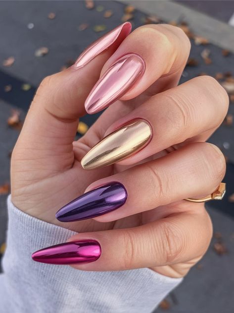 This unique design combines different chrome finishes, featuring rose gold, metallic gold, and deep purple on long almond-shaped nails. The varied metallic shades offer a modern, trendy look for those who like to mix things up. Metal Chrome Nails, Metallic Purple Nails, Deep Pink Nails, Rose Gold And Purple, Purple Chrome Nails, Purple Chrome, Color Block Nails, Pink Chrome Nails, Chrome Nails Designs