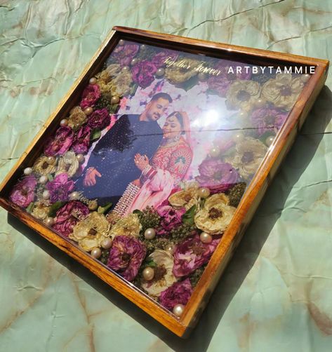 This teakwood frame is exclusively crafted using varmala flowers, capturing the essence of nature's beauty. The vibrant colors of the flowers have been meticulously preserved, enhancing the overall aesthetic appeal of the arrangement.💖✨️🧿 [Teakwood project, teakwoodframe, varmalapreservation, sehra preservation, kaleera preservation, wedding gifts ,anniversary gifts, brides, bridesmaid, bridegroom, resinframe ] #resincrafts #resinartwork #varmalapreserved #anniversary #anniversarygift #anniv... Gifts Anniversary, Resin Artwork, The Flowers, Nature Beauty, Resin Crafts, Bride Groom, Anniversary Gifts, Wedding Gifts, Essence