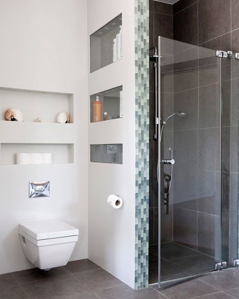 Wall-hung toilet below shelves in niches next to shower cubicle with glass door Wall Hung Toilet With Storage, Glass Door Toilet Room, Small Shower Cubicle, Wall Hung Toilet Ideas, Toilet Niche Design, Niche Wc, Shower Cubicle Ideas, Bathroom Wall Niche, Toilet Niche