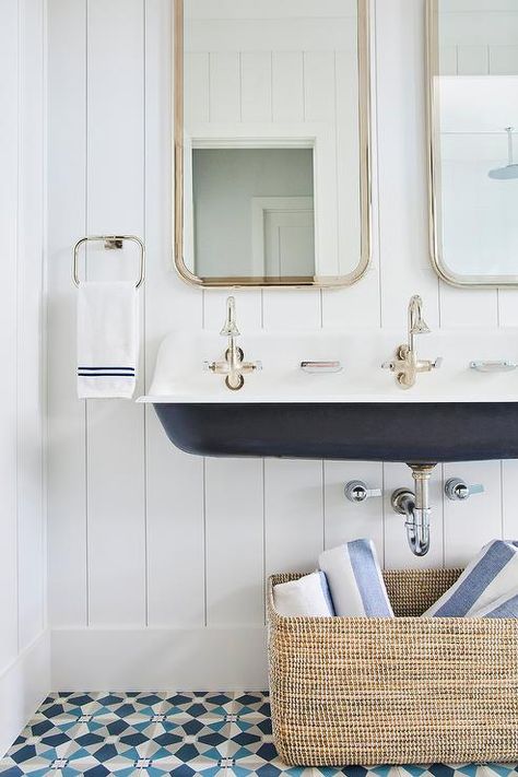 Cottage style boys bathroom boasts a black and white Kohler Brockway sink fixed over gray, black, and green mosaic floor tiles and finished with chrome faucet fitted beneath curved nickel mirrors hung from a vertical shiplap wall. Kohler Brockway Sink, Kohler Brockway, Houses Cottage, Modern Coastal Bathroom, Vertical Shiplap, Cement Tile Shop, Pool Bathroom, Green Mosaic, Shiplap Wall