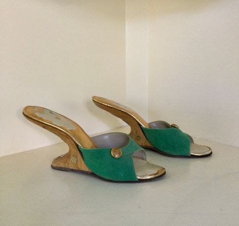 "Rare 1950s green suede boomerang mules with wooden heels.  Vamps are decorated with a golden button ornament and heels have golden disks running along the back curve and on the sides.  Size reads 7N but please refer to measurements below.  They probably fit more like a 6 1/2. Nice vintage condition.  One of the golden accents at the back of the heel is missing and the insoles have lost their shine in areas. This is not visible when worn as it's covered by your foot. There is a tiny notch in one Vintage Gucci Heels, Ball Heels, 90s Heels, Hippie Shoes, Wooden Heels, Gucci Heels, Vintage Heels, Wooden Heel, Green Suede