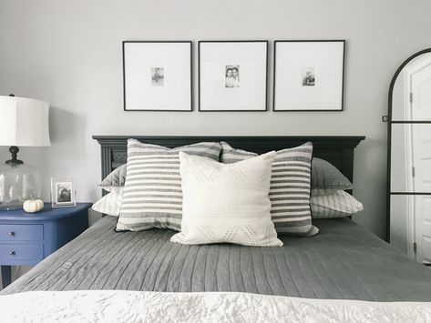 Picture frames above bed