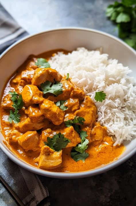 Ingredients: 1 tbsp olive oil, ¼ cup grated onion, 4 minced garlic cloves, 2 tbsp grated ginger, 2 tbsp butter, ¾ cup chicken stock, 8 oz tomato paste, 2 tsp cinnamon, 1½ tsp salt, 2 tsp cumin, 2 tsp garam masala, 1 tsp turmeric, 2½ lbs chicken breasts (cubed), 1½ tbsp lemon juice, 1 cup heavy cream, fresh cilantro, 6 cups cooked basmati rice.  Instructions: Heat olive oil in a skillet. Sauté onion, garlic, and ginger for 2-3 mins. Add butter, chicken stock, tomato paste, and spices; stir to combine. Add chicken, cover, and cook for 15 mins. Stir in lemon juice and cream, simmer 2 mins. Serve over rice, garnished with cilantro.  Prep Time: 15 mins | Cook Time: 25 mins | Total Time: 40 mins | Kcal: 450 | Servings: 6 Chicken Curry With Rice, Creamy Butter Chicken, Curry And Rice, Rice And Curry, Serve Over Rice, Chicken Tikka Masala Recipes, Homemade Comfort Food, Tikka Masala Recipe, Chicken Curry Recipe