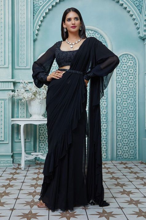 Buy #black #draped #saree with #ruffle borders. Paired with #floral #embroidered puff #sleeve #blouse & embroidered belt by #AriyanaCouture at #AzaFashions Shop online now at #Azafashions.com Call +91 8291990059 or email contactus@azafashions.com for enquiries. #wedding #festive #ethnic #tradional #shopping #shoponline #party #reception #bride Black Saree Designs, Long Sleeve Saree Blouse, Black Saree Blouse, Full Sleeves Blouse Designs, Black Blouse Designs, Saree Jacket Designs, Embroidered Cuffs, Saree With Belt, Draped Saree