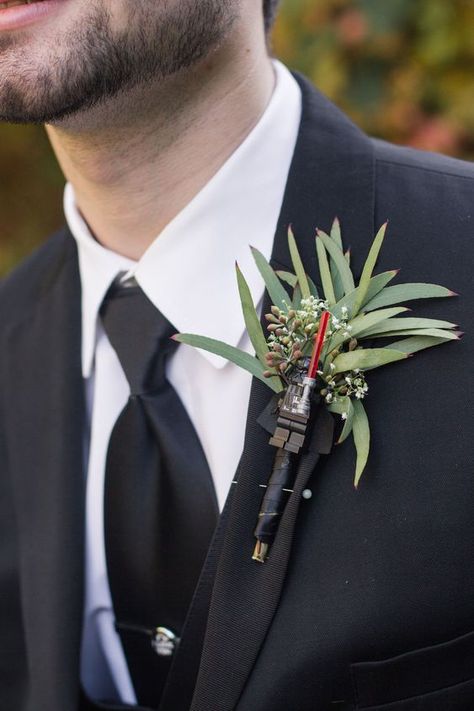 Picture Of a Darth Vader wedding boutonniere with much greenery is ideal for Star Wars or for a groom who is a big fan Starwars Wedding Colors, Star Wars Wedding Boutonniere, Star Wars Wedding Groomsmen, Starwars Boutonniere, Star Wars Vow Renewal, Star Wars Wedding Ideas Subtle, Star Wars Aesthetic Wedding, Star Wars Wedding Ceremony, Star Wars Wedding Color Scheme