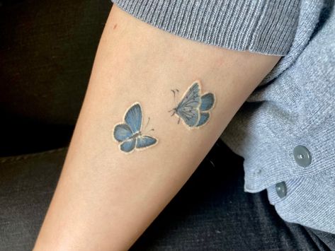 Two delicate blue butterflies are tattooed onto the forearm with black and white detailing Butterfly Tattoo On Forearm, Small Blue Butterfly, Common Blue Butterfly, Blue Butterfly Tattoo, Tattoo On Forearm, Holly Blue, Small Butterfly Tattoo, Small Butterfly, Forearm Tattoos