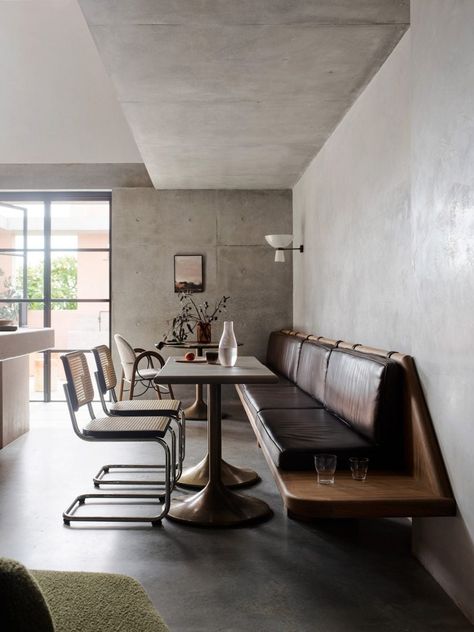 A "cafe-style" area provides seating for staff. Concrete Staircase, Room Bookshelf, Small Workspace, Building Renovation, Banquette Seating, Cafe Style, Workplace Design, Self Design, Banquette